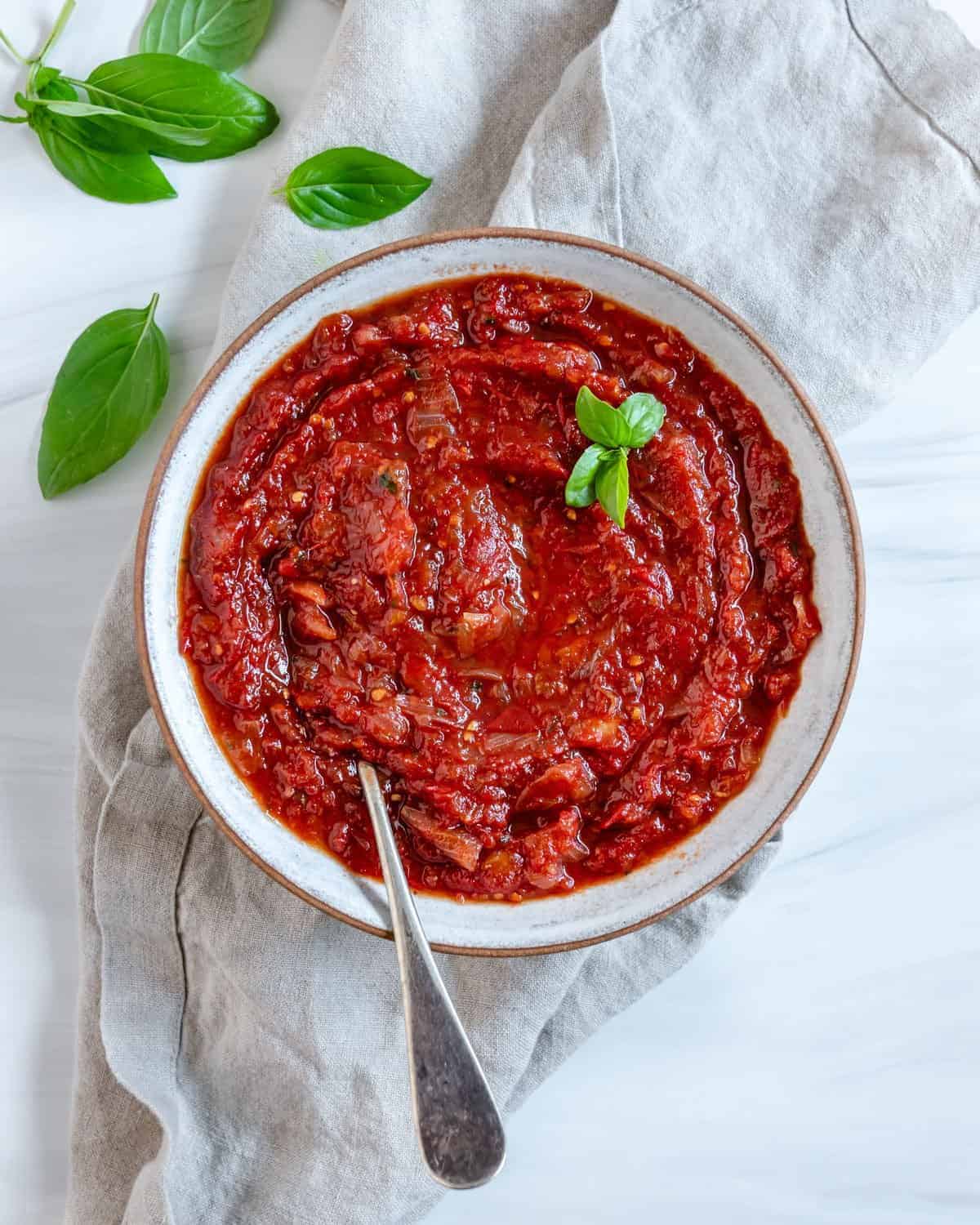 completed Sweet Tomato Chutney in a white bowl against a white background