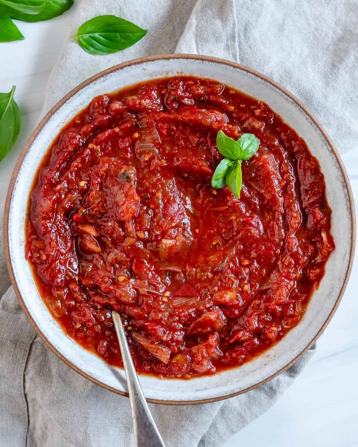 completed Sweet Tomato Chutney in a white bowl against a white background