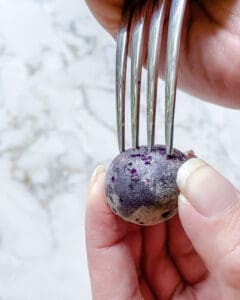 process of making small holes in raw small potatoes