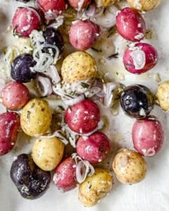 process of making Roasted Rosemary Potatoes against white parchment paper