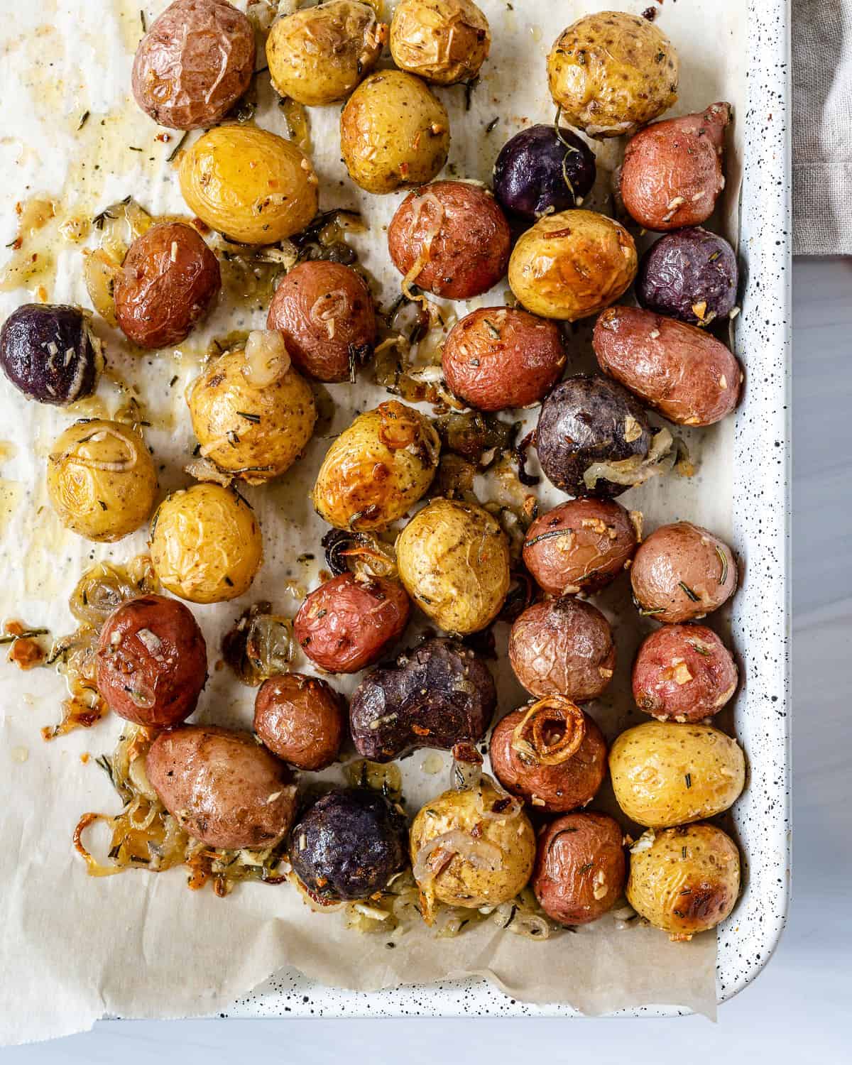 completed Roasted Rosemary Potatoes in a white tray