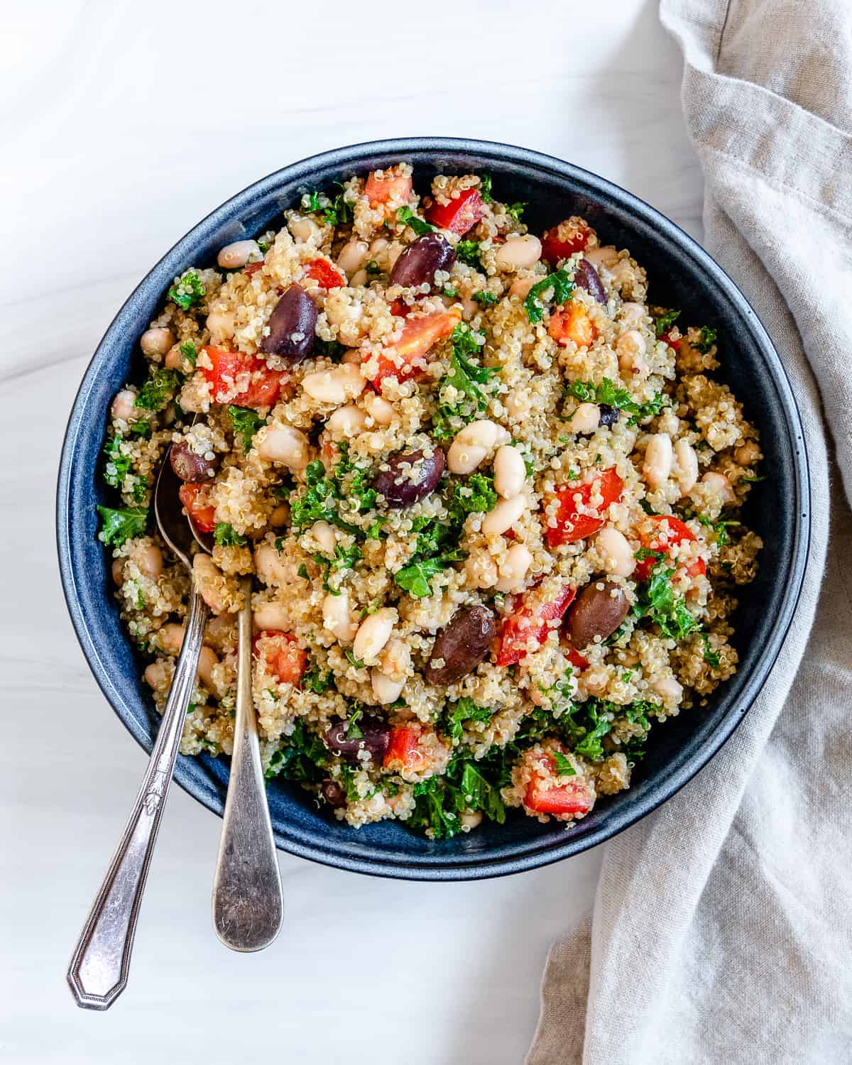 completed Lemon Garlic Quinoa in a blue bowl against a white background