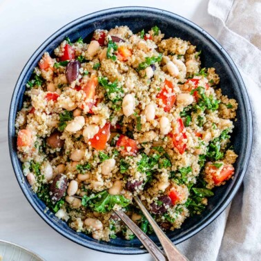 completed Lemon Garlic Quinoa in a blue bowl against a white background