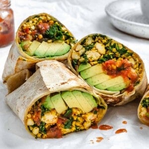 completed Easy Scrambled Tofu Breakfast Burritos on a white surface