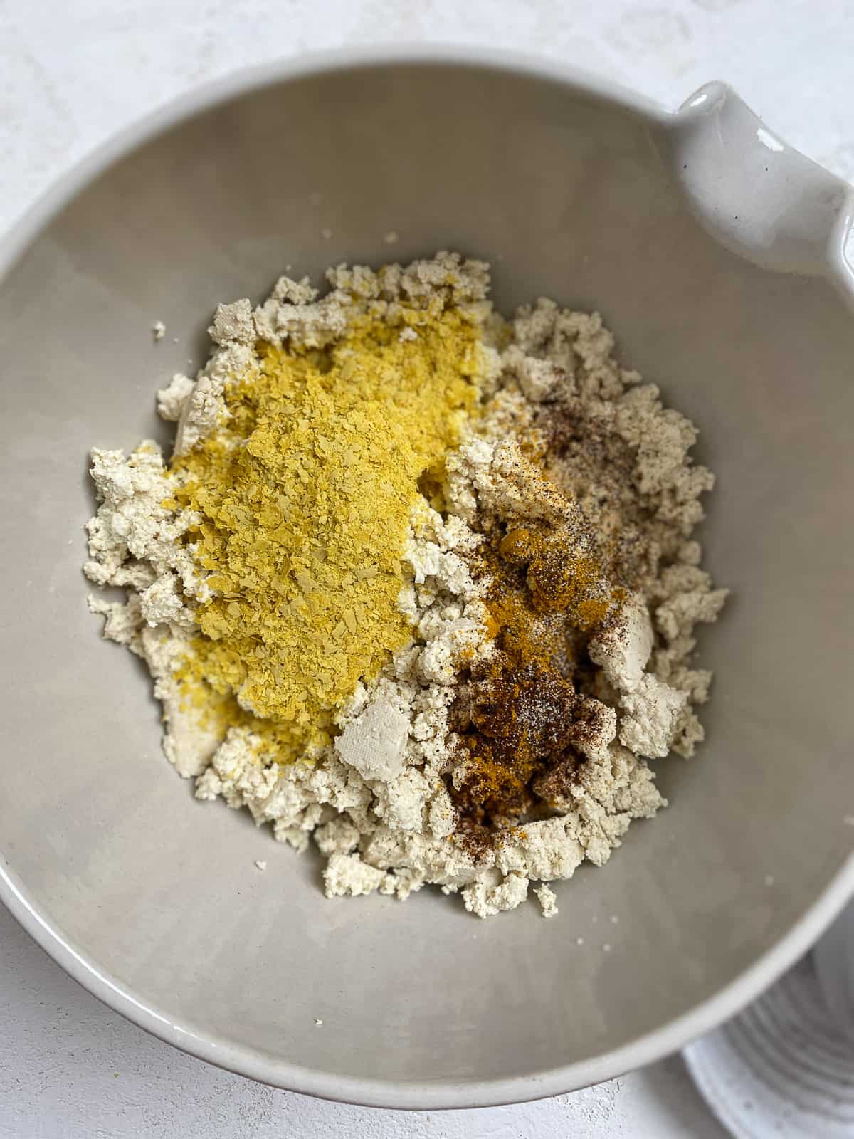 process shot of adding tofu mixture together in bowl