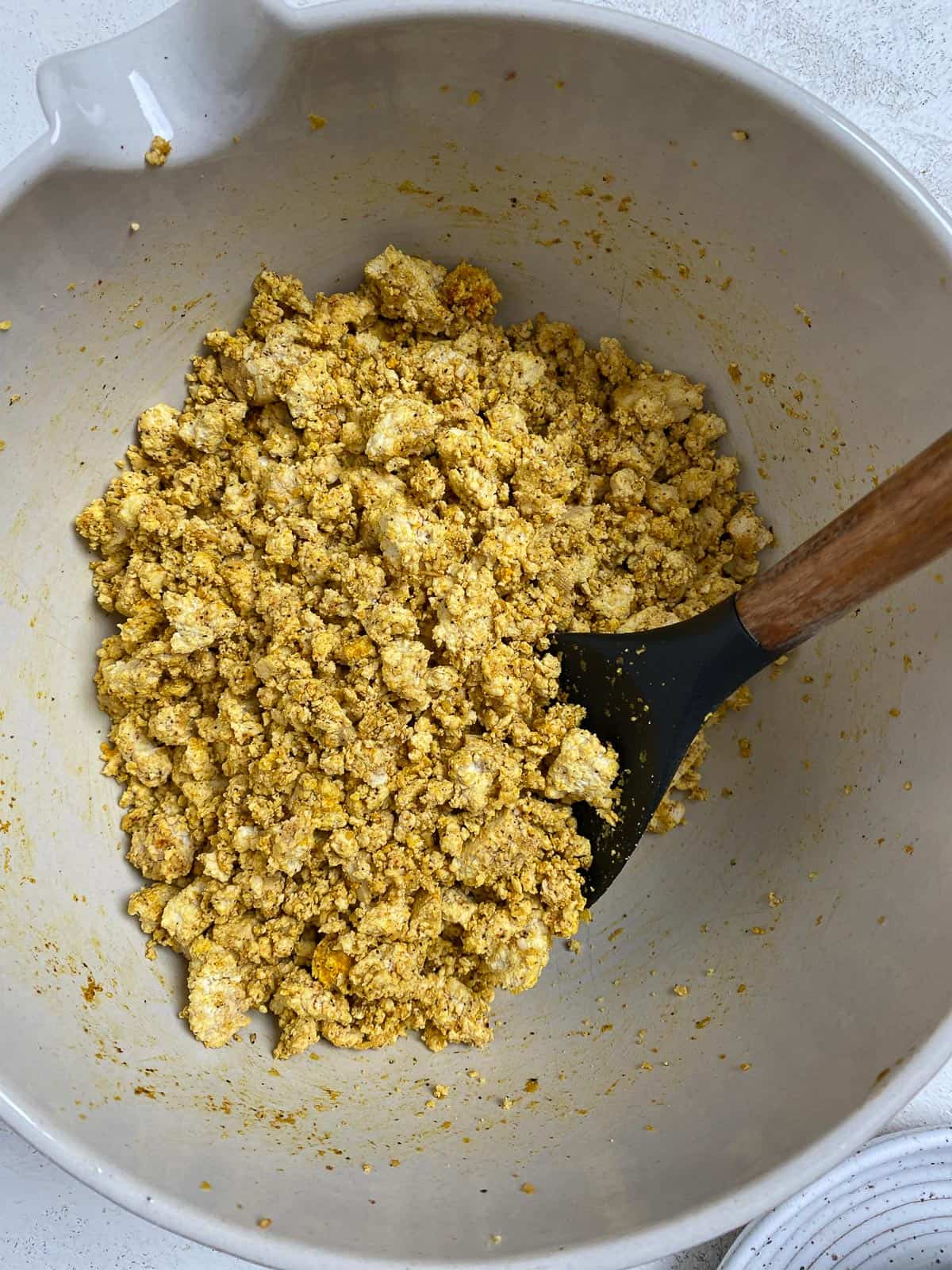 process shot of mixing tofu mixture in bowl