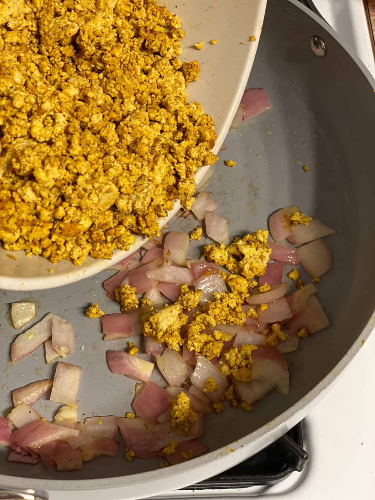 process shot of adding tofu mixture to pan