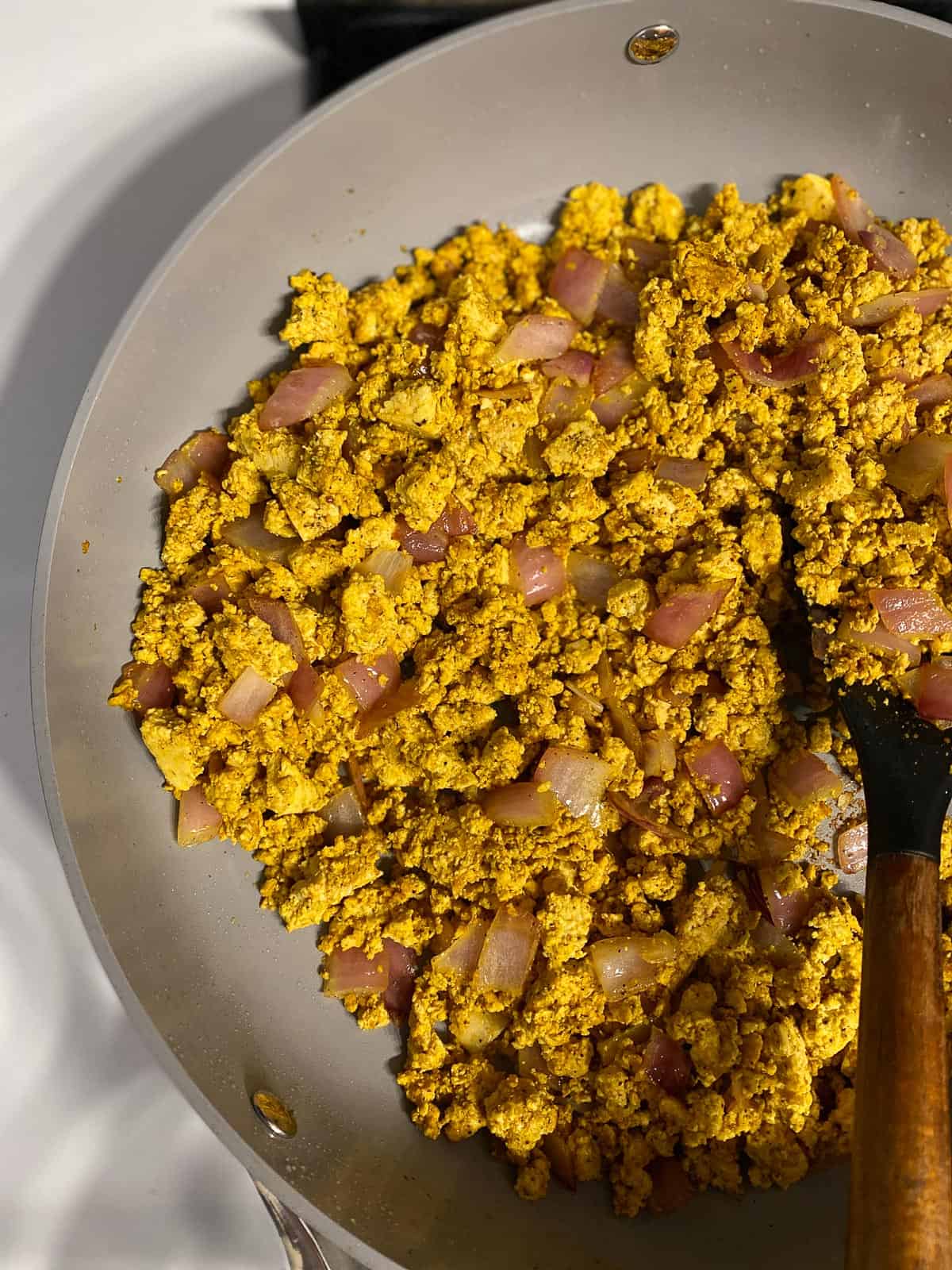 process shot of mixing tofu mixture in pan