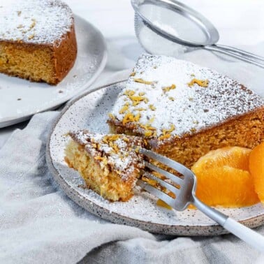 completed slice of Orange Olive Oil Cake against a white background