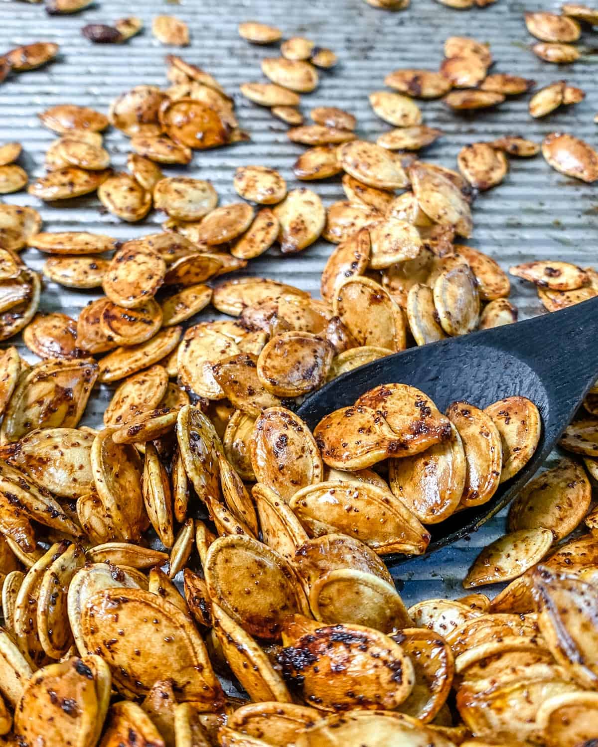 completed roasted spicy pumpkin seeds on a tray