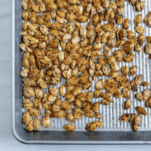 completed roasted spicy pumpkin seeds on a tray