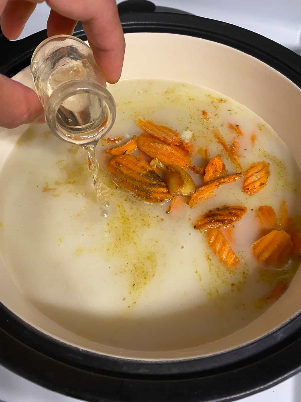 process shot of adding vinegar to pan