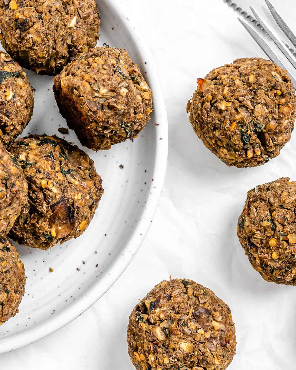 completed Vegan Lentil Meatballs plated and scattered on a white surface