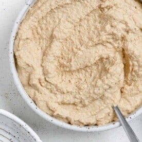 completed Vegan French Onion Dip in a white bowl against a light background