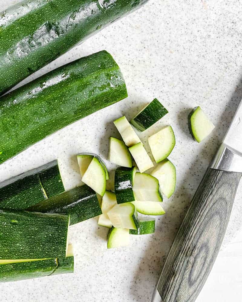 sliced cucumber against a white background