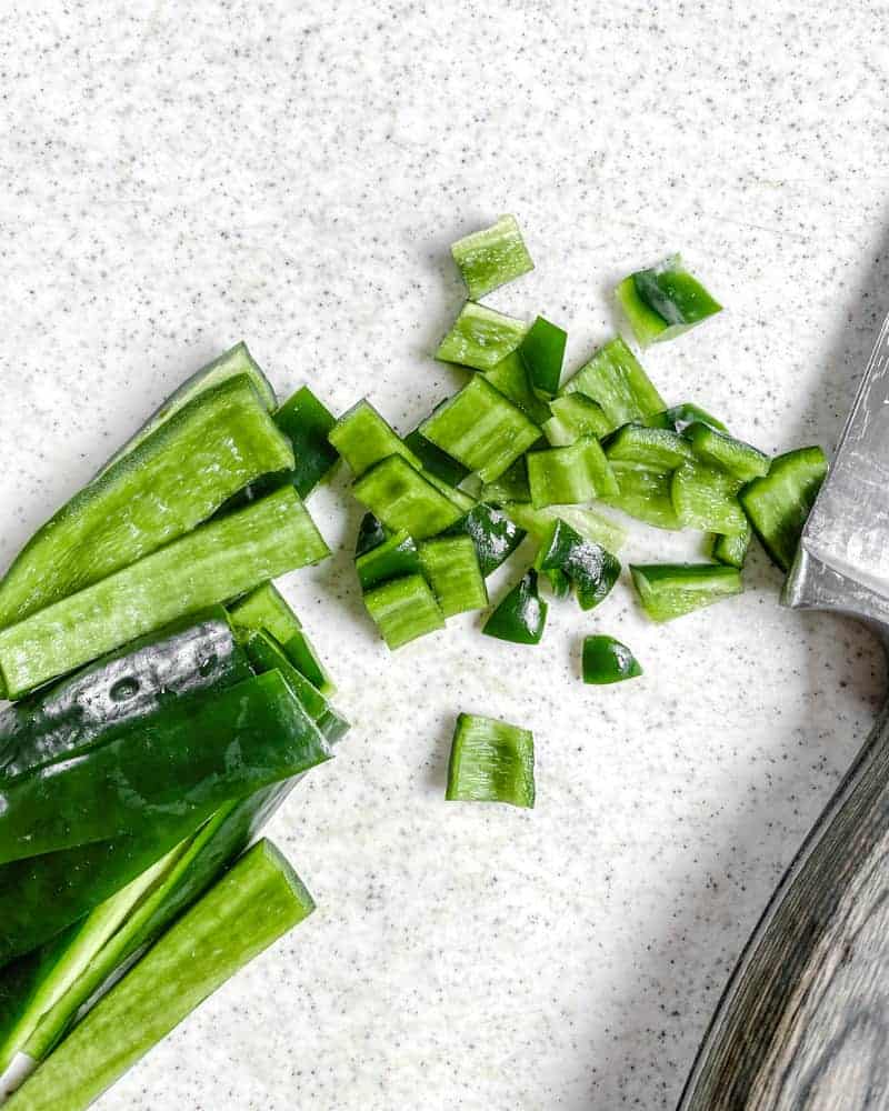 chopped celery against a white background