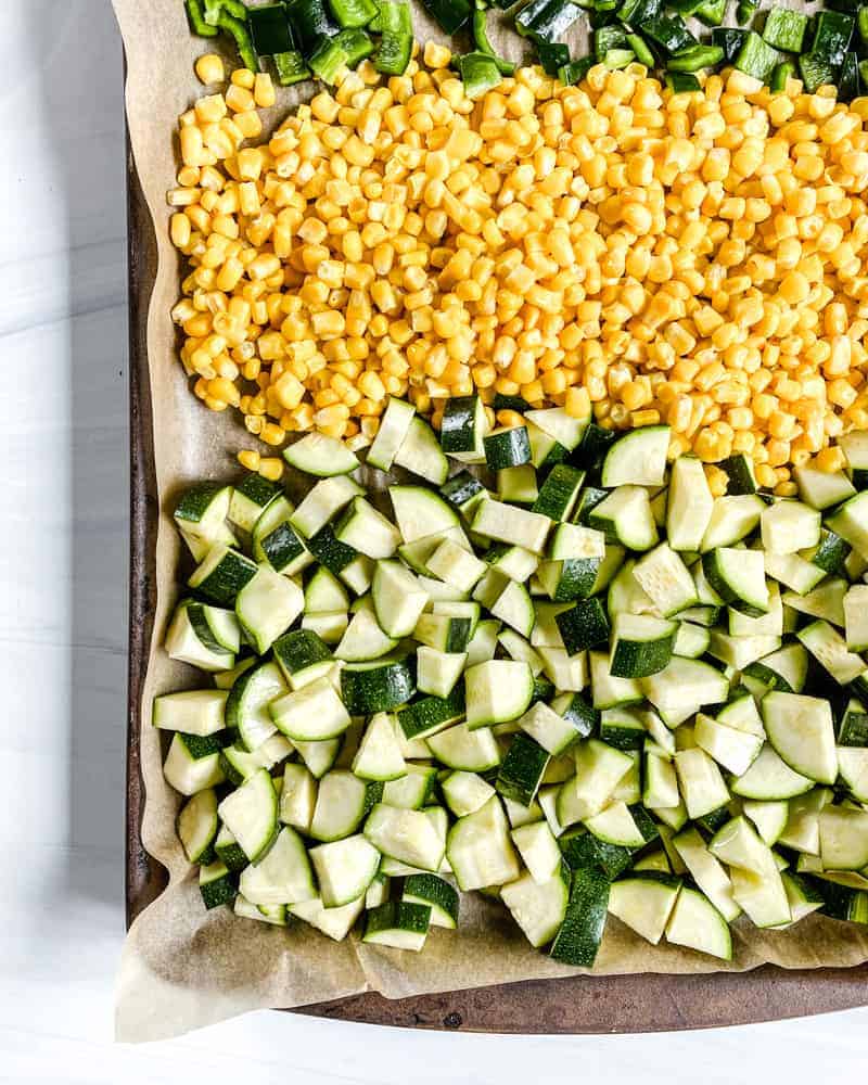 chopped ingredients in a baking sheet against a white background