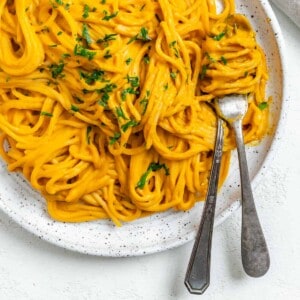 completed Sweet Potato Pasta Sauce with Spaghetti plated against a white surface