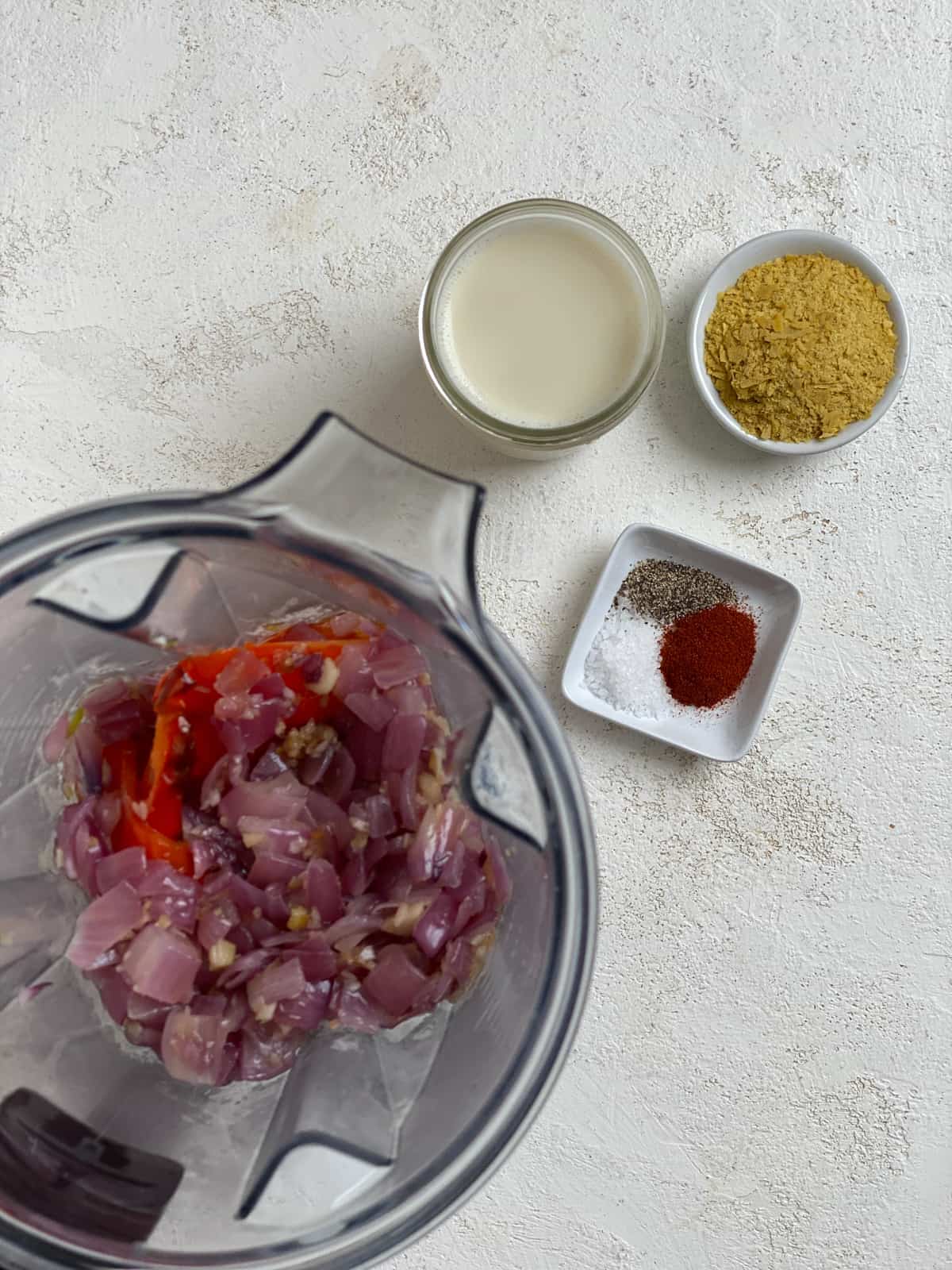 measured out seasoning alongside blender of veggies