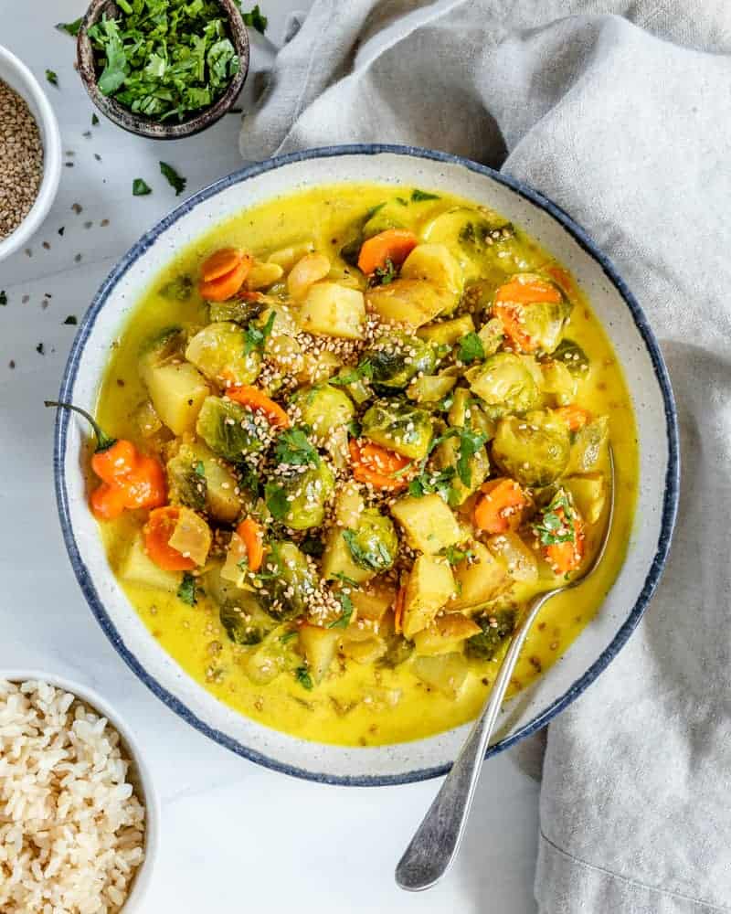 completed brussels sprouts in a bowl against a white background