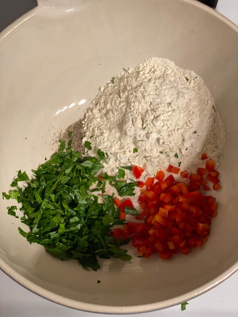 process shot of mixing ingredients together in a bowl