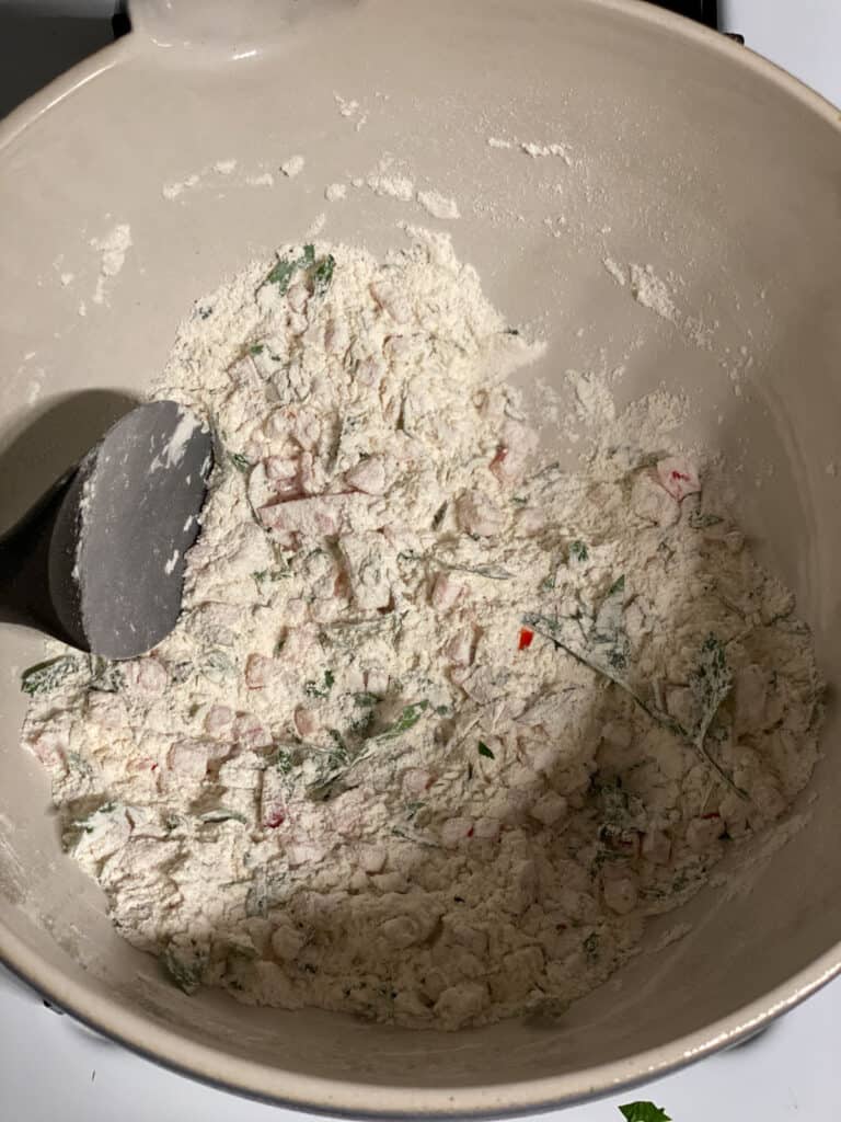 process shot of mixing ingredients together in a bowl