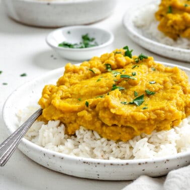 completed Easy Yellow Dal on rice in a white plate against a light background