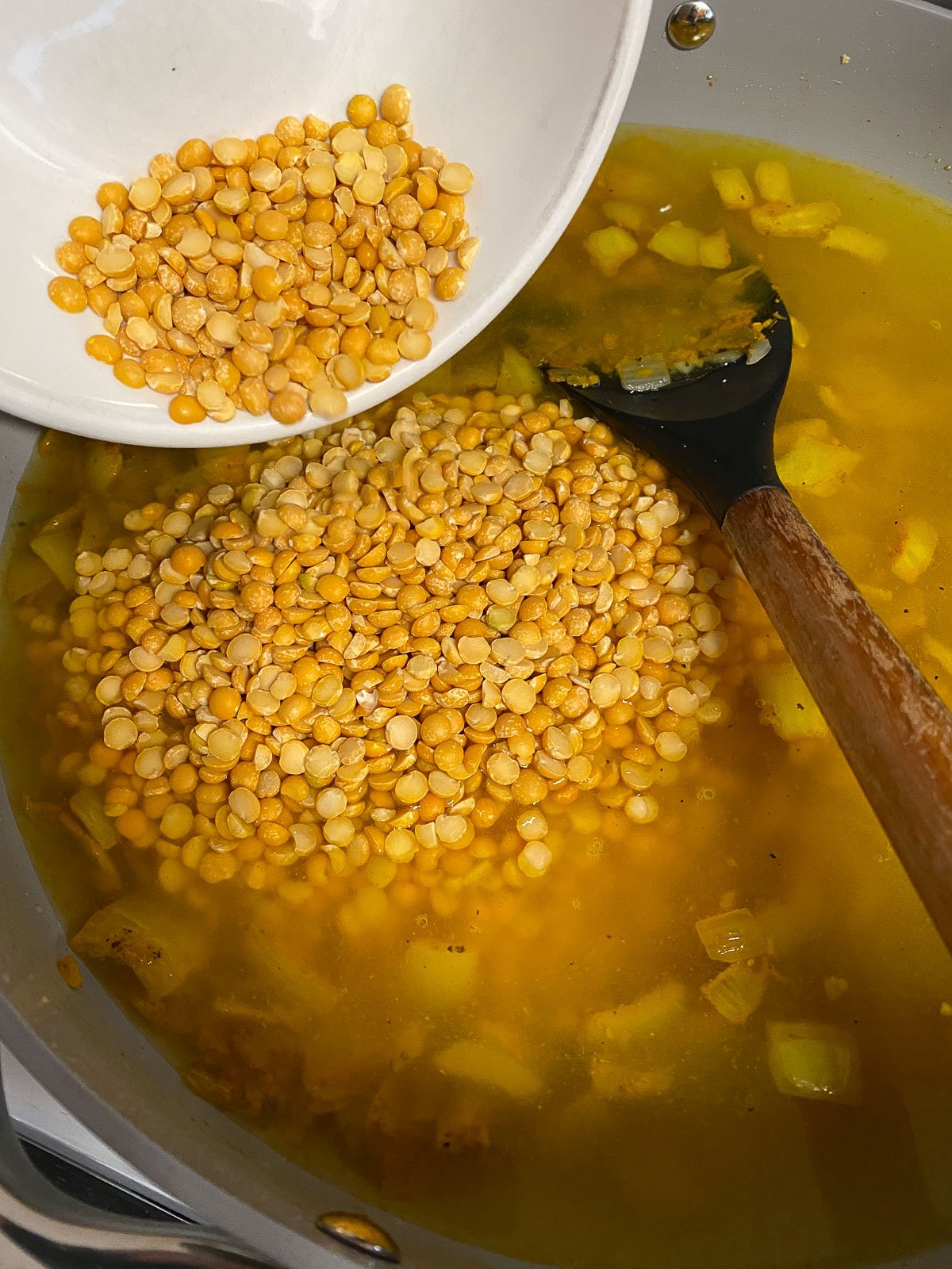 process shot of lentils added to pan