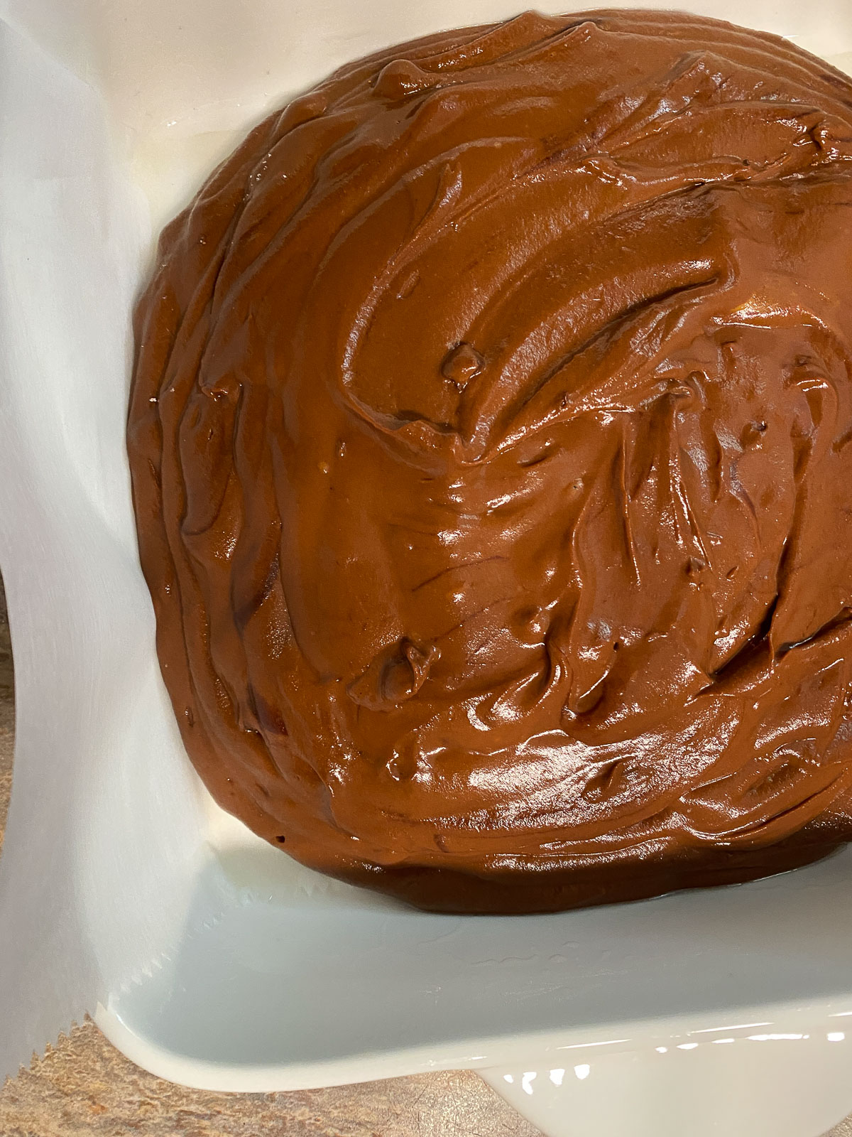 post pouring Sweet Potato Brownie mixture into white baking tray