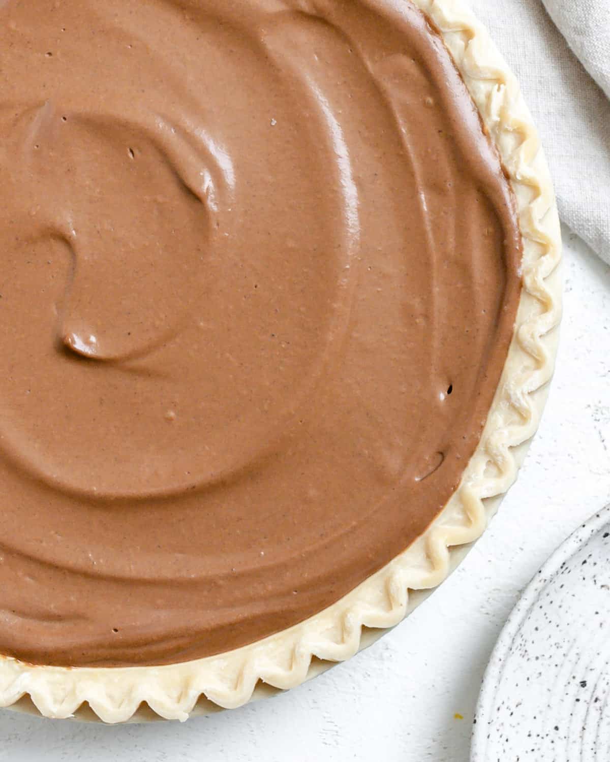 completed Chocolate Pumpkin Pie against a white surface