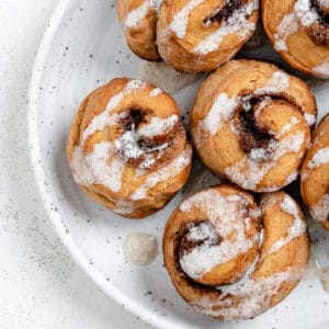 completed Cinnamon Rolls plated against a white surface