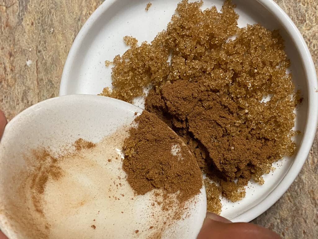 process shot of mixing brown sugar and cinnamon together in bowl