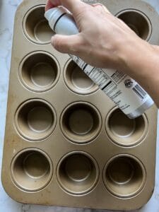 process of spraying spray on oil on muffing tin tray