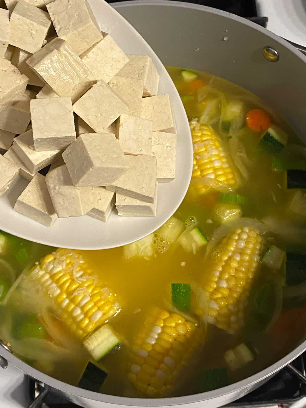 process shot of adding tofu to pan