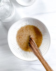 process of making flaxseed egg in a white bowl against a white surface