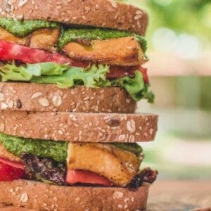 completed stack of Tofu and Pesto Sandwich against an outdoor background