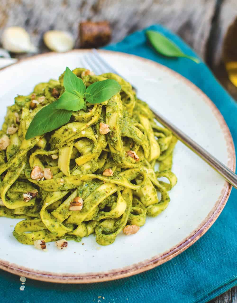 Walnut pesto pasta on a white plate.