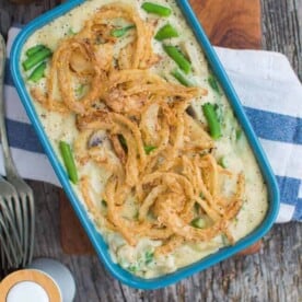 completed Green Bean Casserole in a blue tray against a dark gray surface