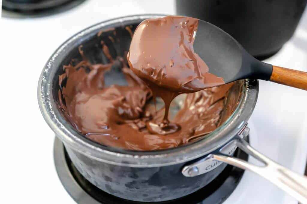 Saucepan with glass bowl and chocolate chips