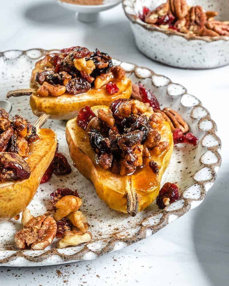 completed baked pears in a white plate against a white background