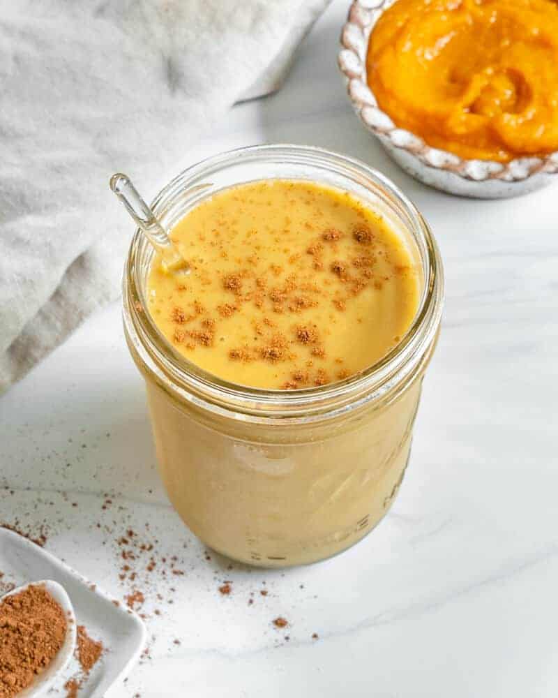 Pumpkin Pie Smoothie in glass jar on white surface