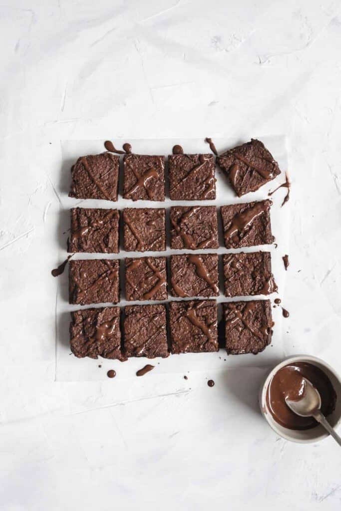 finished pumpkin chocolate brownies cut into pieces against a white background