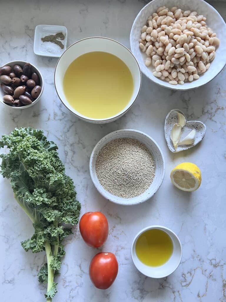 ingredients measured out for Lemon Garlic Quinoa against a white marble surface