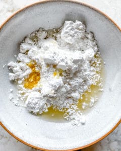 process of showing the mixture of ingredients for lemon loaf in bowl