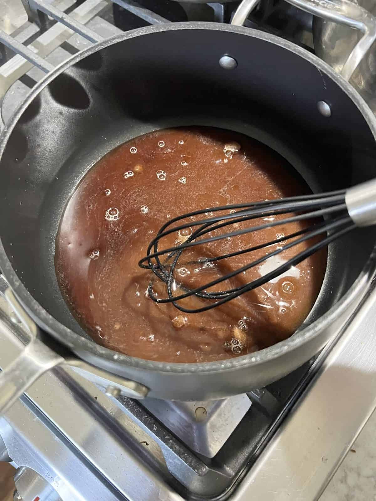 process of adding ingredients to pot for sweet tomato chutney