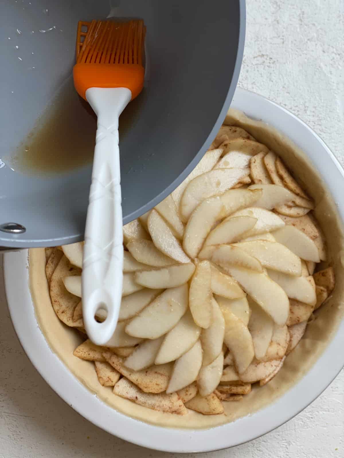 process shot of glaze being spread onto top of pie