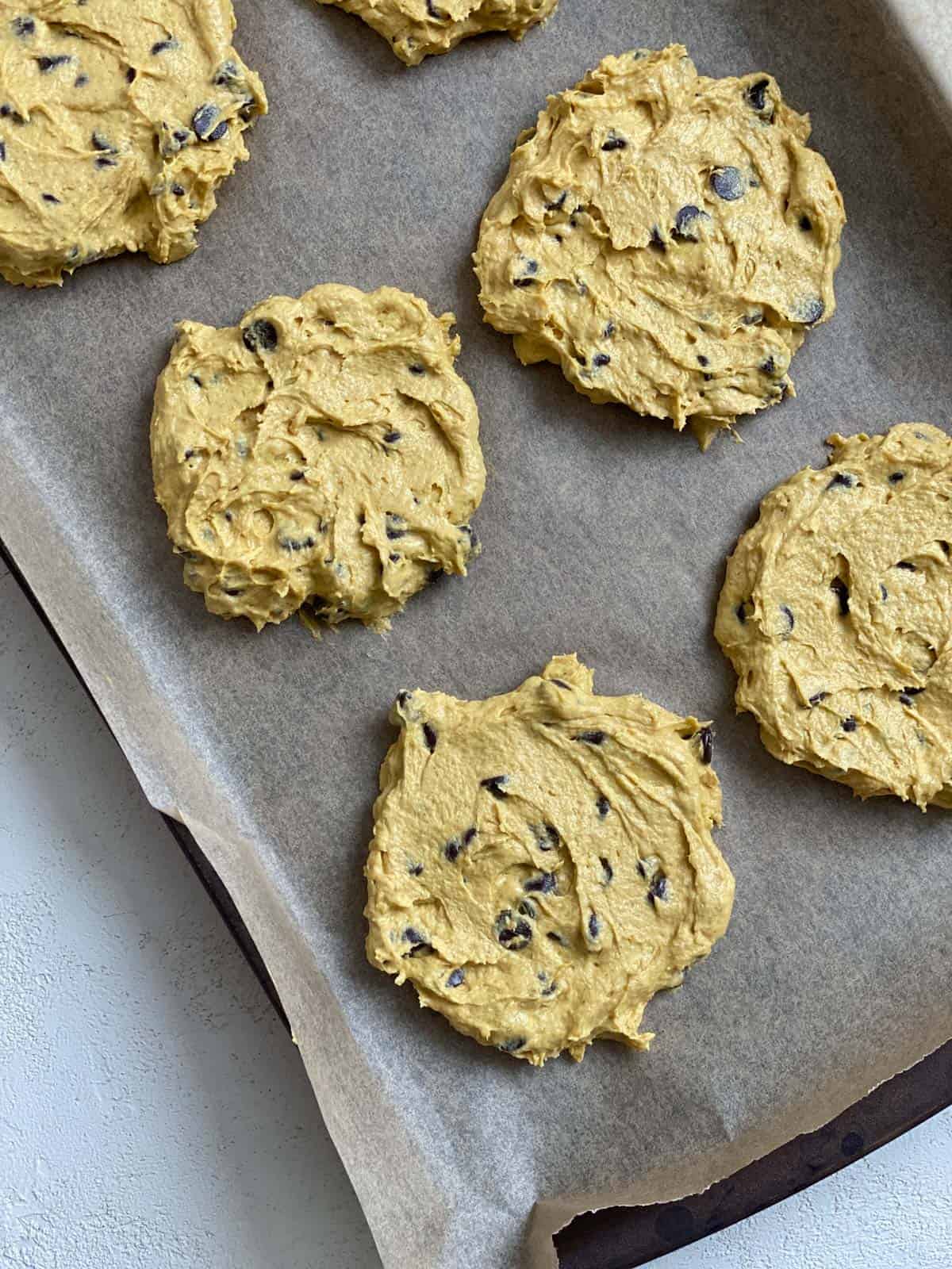 unbaked Vegan Pumpkin Chocolate Chip Cookies on a cookie sheet