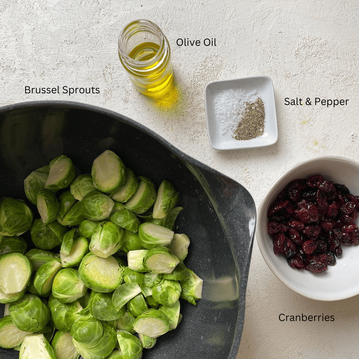 ingredients for Roasted Brussels Sprouts with Cranberries against a light surface