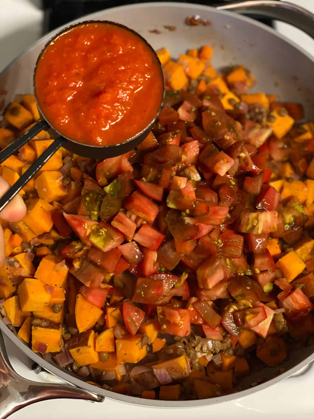 process shot of adding passata to pan