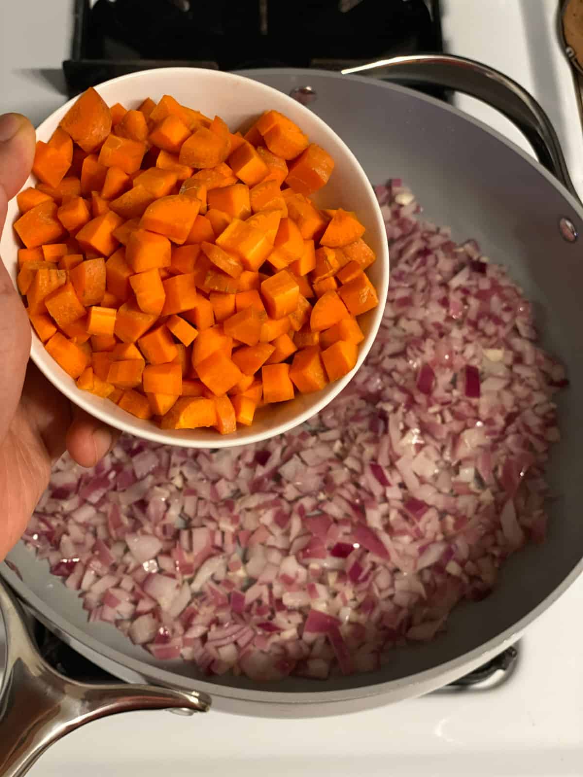 process shot of adding carrots to pan